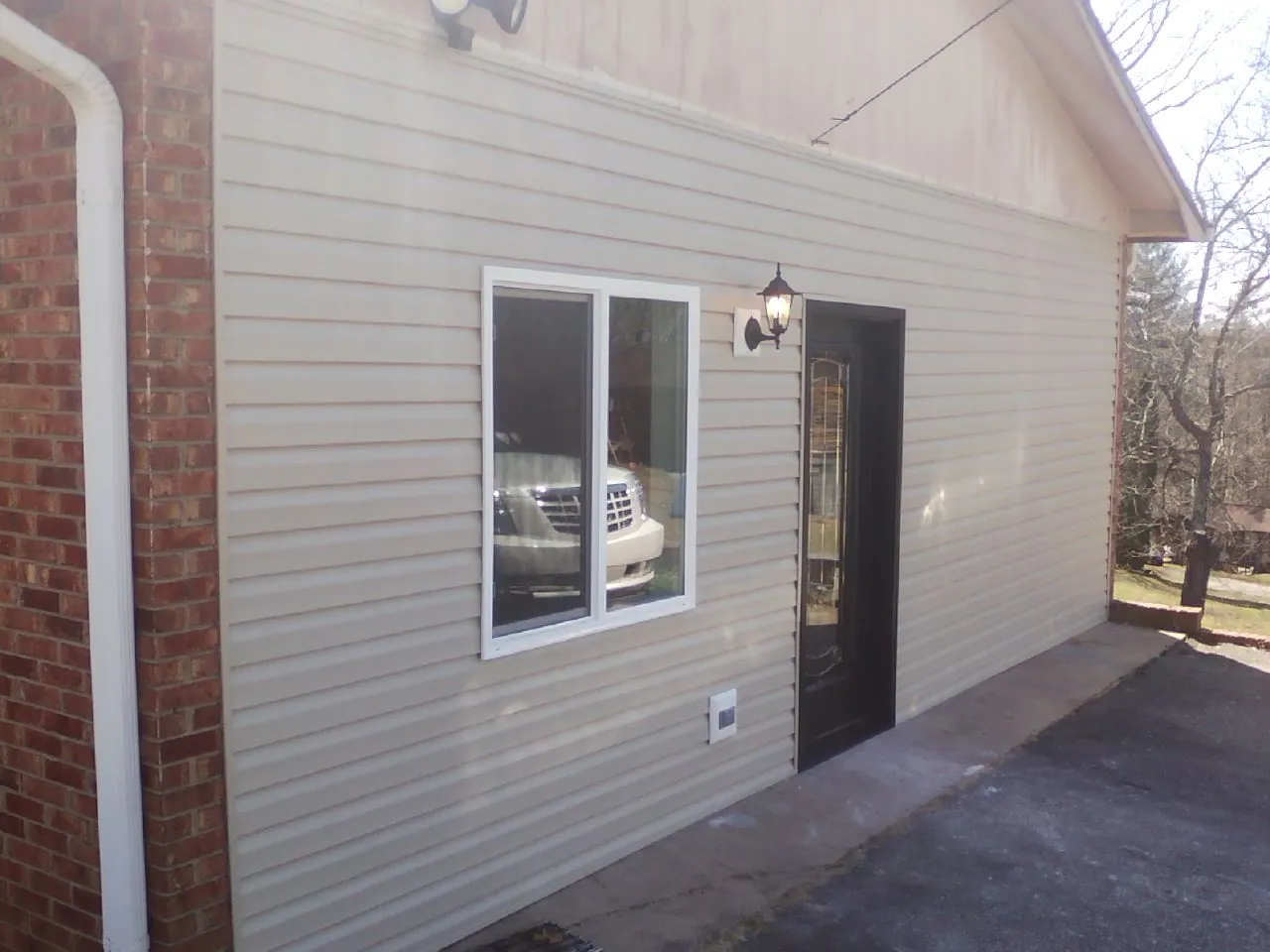 New vinyl siding and entry door on a room addition in Oakland City