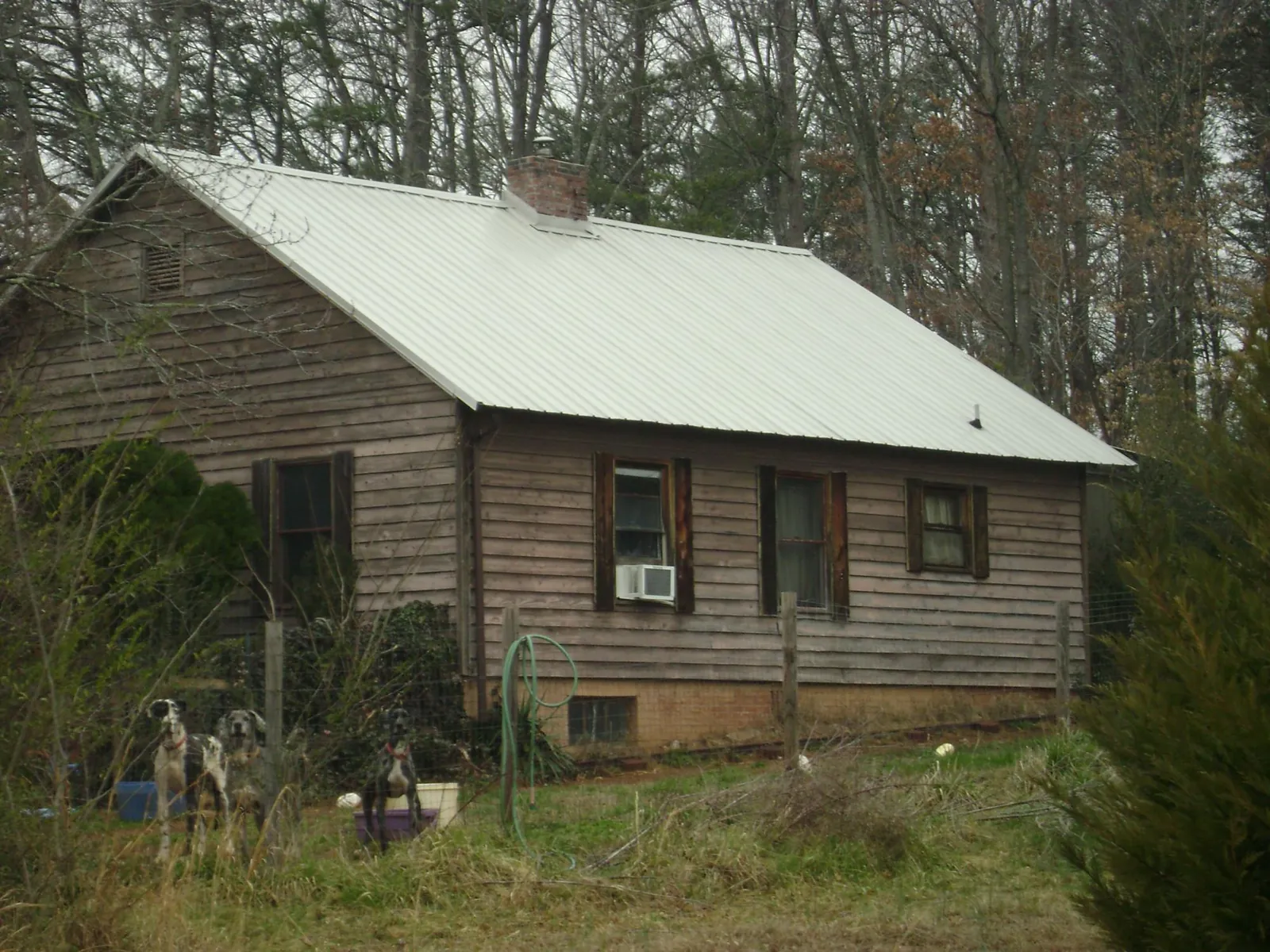 White metal roof on an old wood sided farmhouse, from a Asphalt Shingle Roof Repair job in Oakland City